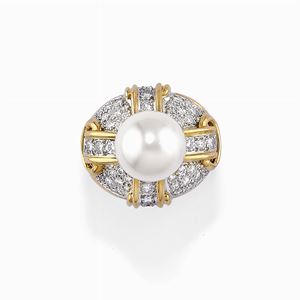 A 18K two color gold, pearl and diamond ring