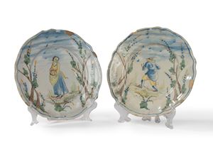 Two painted majolica plates with a central figure and trees, Savona