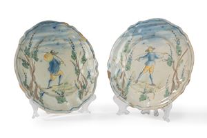 Two painted majolica plates with a central figure and trees, Savona