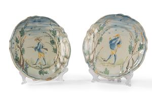 Two painted majolica plates with a central figure and trees, Savona