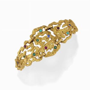 A 18K yellow gold, ruby, sapphire, emerald and turquoise bangle