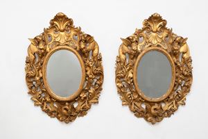 - Pair of large oval mirrors in carved and gilded wood, 19th century