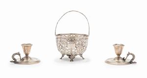 A silver basket and two candlesticks