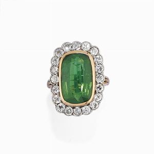 A low-carat gold, green gemstone and diamond ring