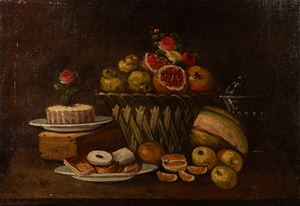 Pomegranates and other fruits in a wicker basket and biscuits on a table