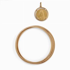 A 18K yellow gold with british pound, bangle
