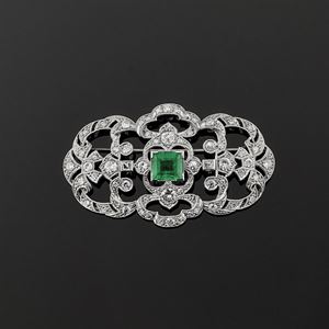 A 18K white gold, diamond and emerald brooch