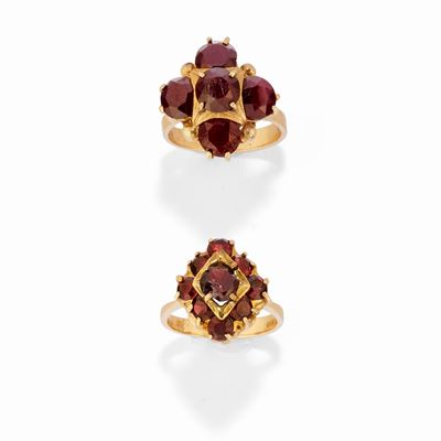 Due anelli in oro giallo 18k con granati rotondi