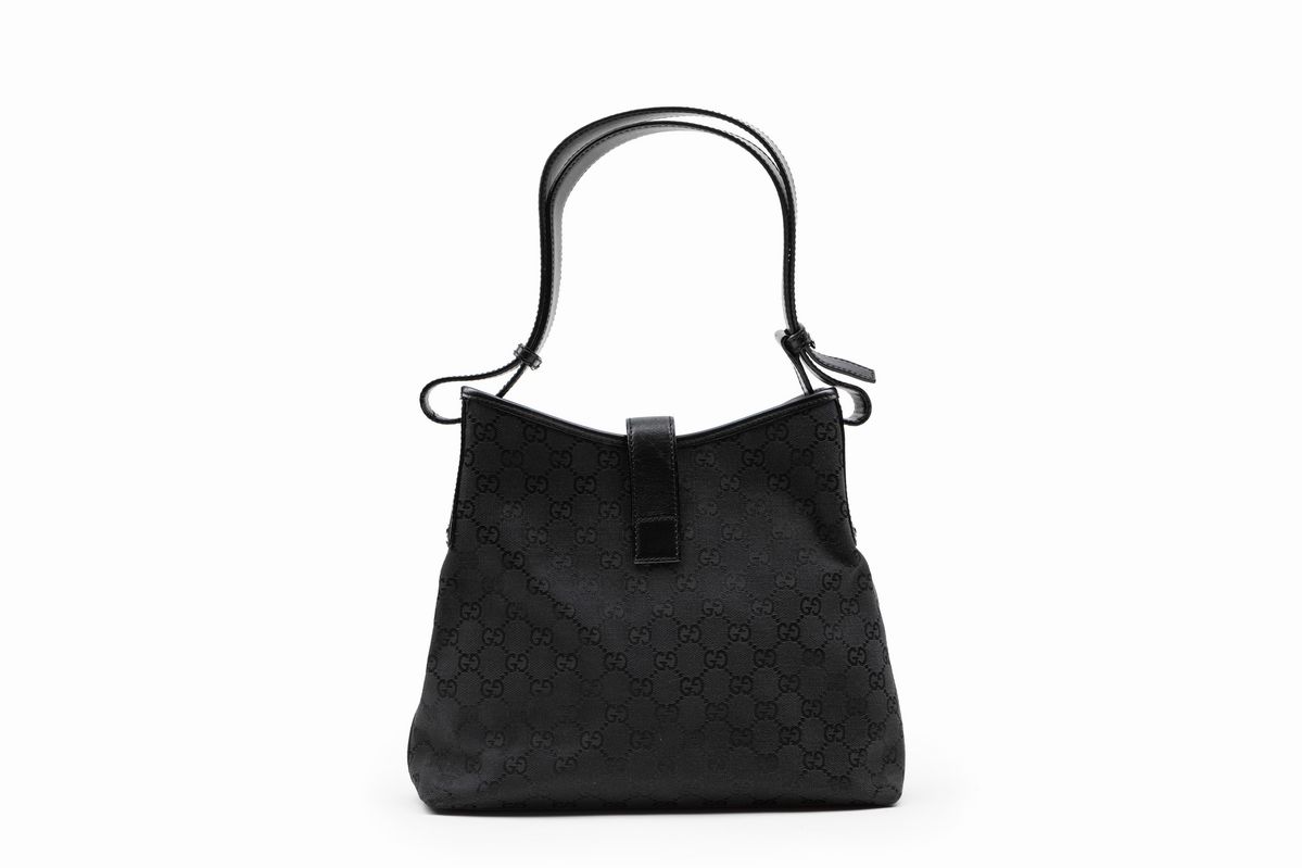 Gucci - Borsa in tela logata nera con tracolla in pelle e chiusura a pistone in metallo