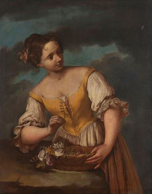 Young woman with flowers in a wicker basket