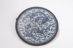 A ROUND PORCELAIN PLAQUE
