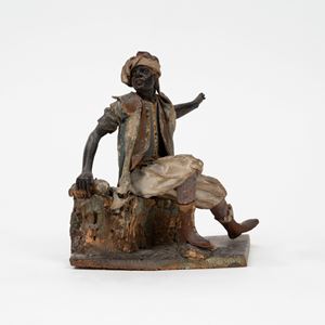 Figura da presepe in cartapesta, tela e legno di tiglio dipinto, raffigurante moro seduto, Sicilia, secolo XVIII