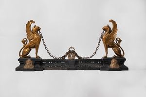  - Pair of iron andirons with winged lions, 19th century