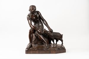 Wooden sculpture depicting a boy with a goat