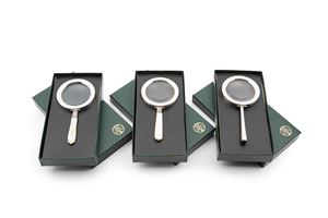 Three silver and mother of pearl desk lenses