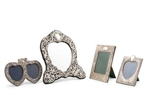 Three silver photo frames and a table mirror