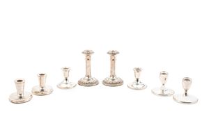 Four pairs of sterling silver candlesticks