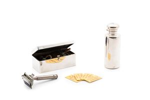A shaving set and a silver perfume bottle
