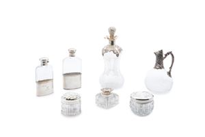 Four bottles and three boxes in silver, glass and crystal