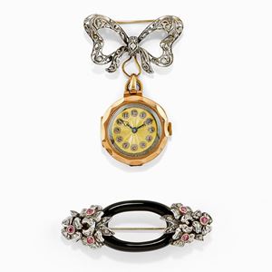 Two silver, low-carat gold, onyx, ruby and diamond brooches