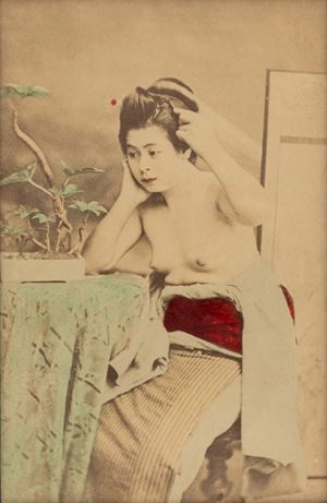 Girl at a little table with a Bonsai