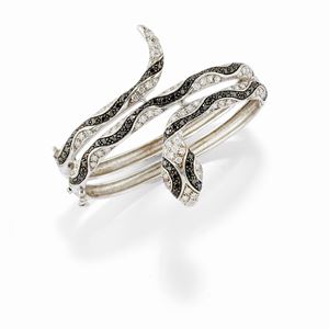 A 18K white gold, uncolored and black diamond bangle