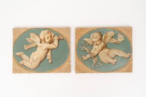 Coppia di dipinti ovali raffiguranti putti alati