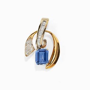A 14K two-color gold, diamond and synthetic corundum pendant