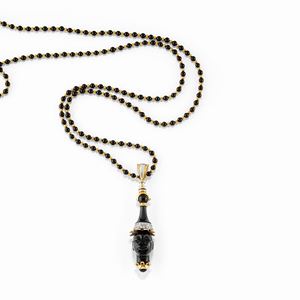 A two-color gold, diamond and onyx necklace