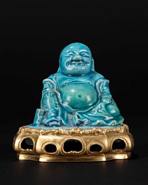 A ormolu-mounted turquese glazed figure of Budai