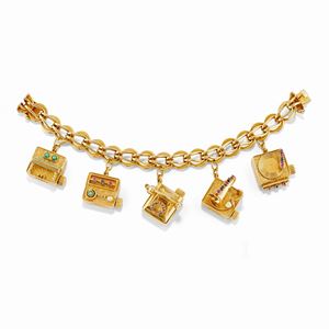 A 14K yellow gold, ruby, sapphire, pearl and turquoise charms bracelet