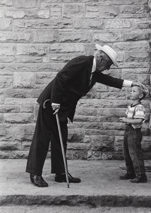 Frank LLoyd Wright caressing a child