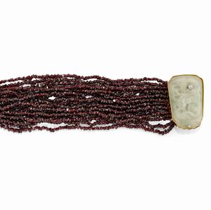 A 18K two-color gold, garnet, jadeite and diamond bracelet