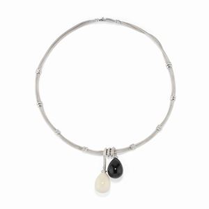 A 18K white gold, onyx, agate and diamond necklace and earrings.