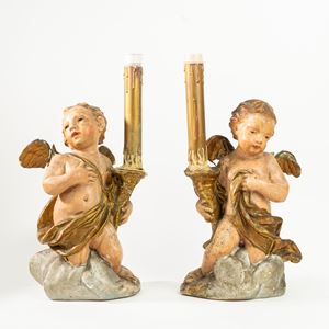 Pair of ancient torch-holding angels in polychrome painted terracotta