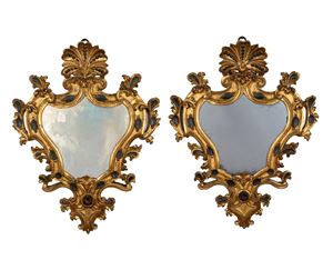 Pair of curved mirrors in carved, gilded and painted wood with leaf scrolls, palmette cymatium, 19th century