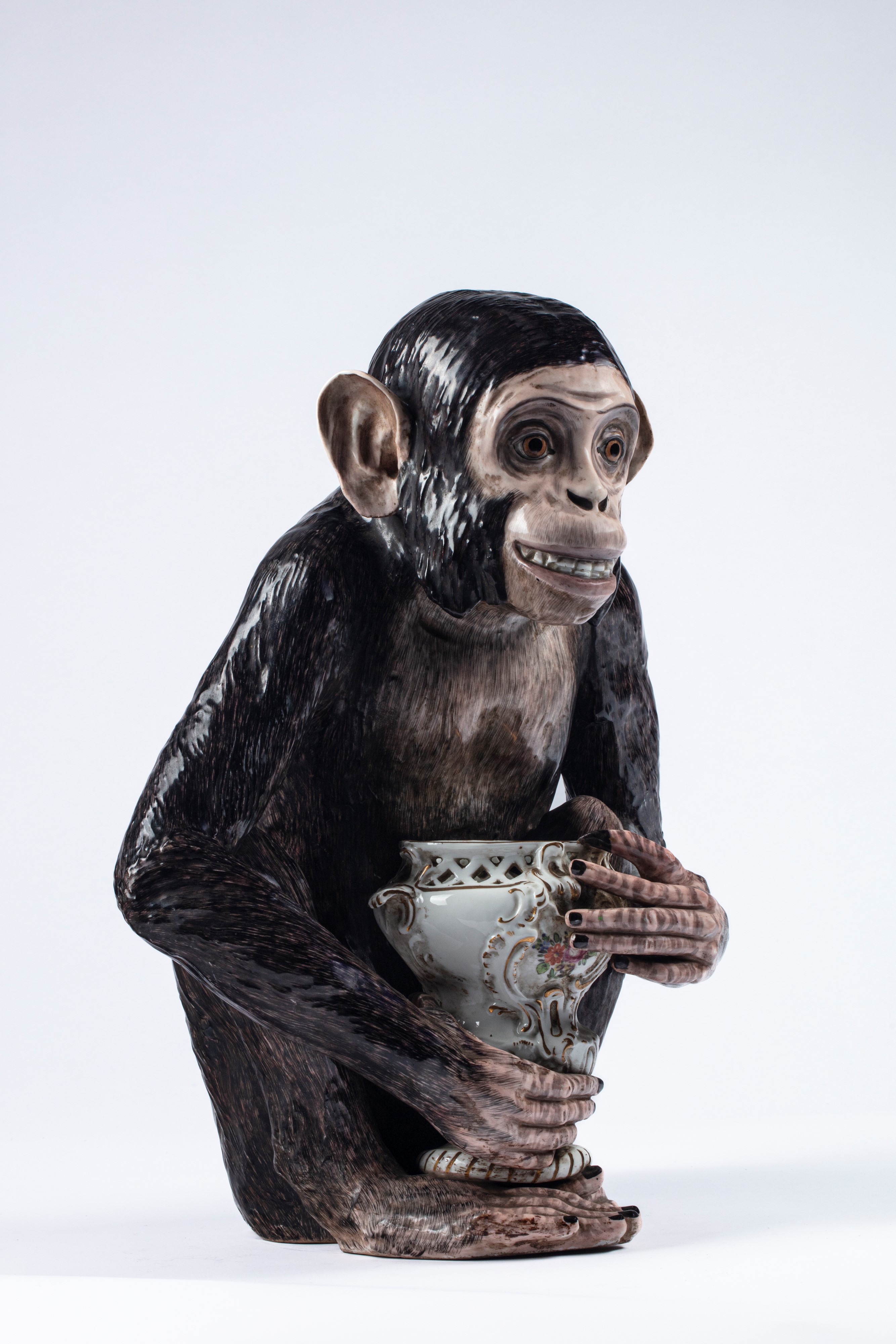 A Capodimonte porcelain monkey with vase. Late 19th/early 20th