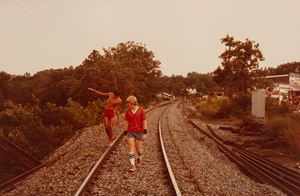 Senza titolo (Two boys walking on railroad tracks)