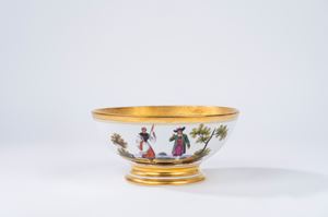 White and gold porcelain bowl decorated in polychrome with figures in costume in landscapes, France, 19th century