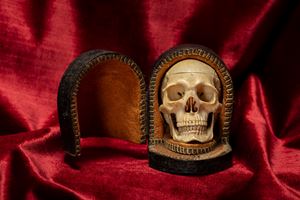 A 19th century northern european ivory skull memento mori, with leather box.