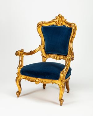 A carved and gilt wood armchair, 19th century, with blue velvet fabric. From the collection of mr Stefano Gabbana