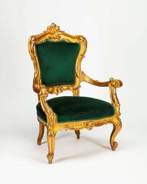 A carved and gilt wood armchair, 19th century, with green velvet fabric. From the collection of mr Stefano Gabbana