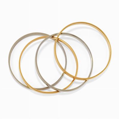 Bracciali in oro bicolore 18K, lotto di quattro esemplari