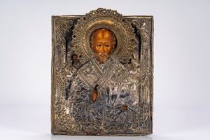Icona a tempera su tavola con riza in argento raffigurante san Nicola benedicente tra santi. Russia, XIX secolo