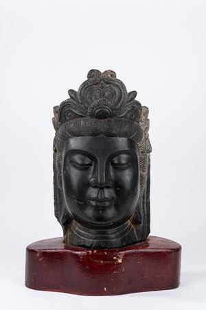 Large black stone head of Buddha, in archaic style, China, early 20th century