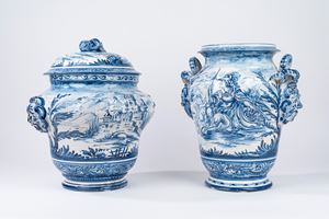 Two large historiated vases in white and blue majolica, one of which has a lid