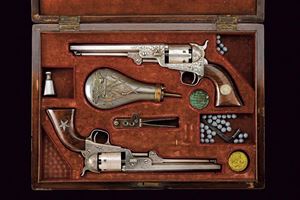 An important pair of cased Gustave Young style factory-engraved Colt Model 1851 Navy Revolvers
