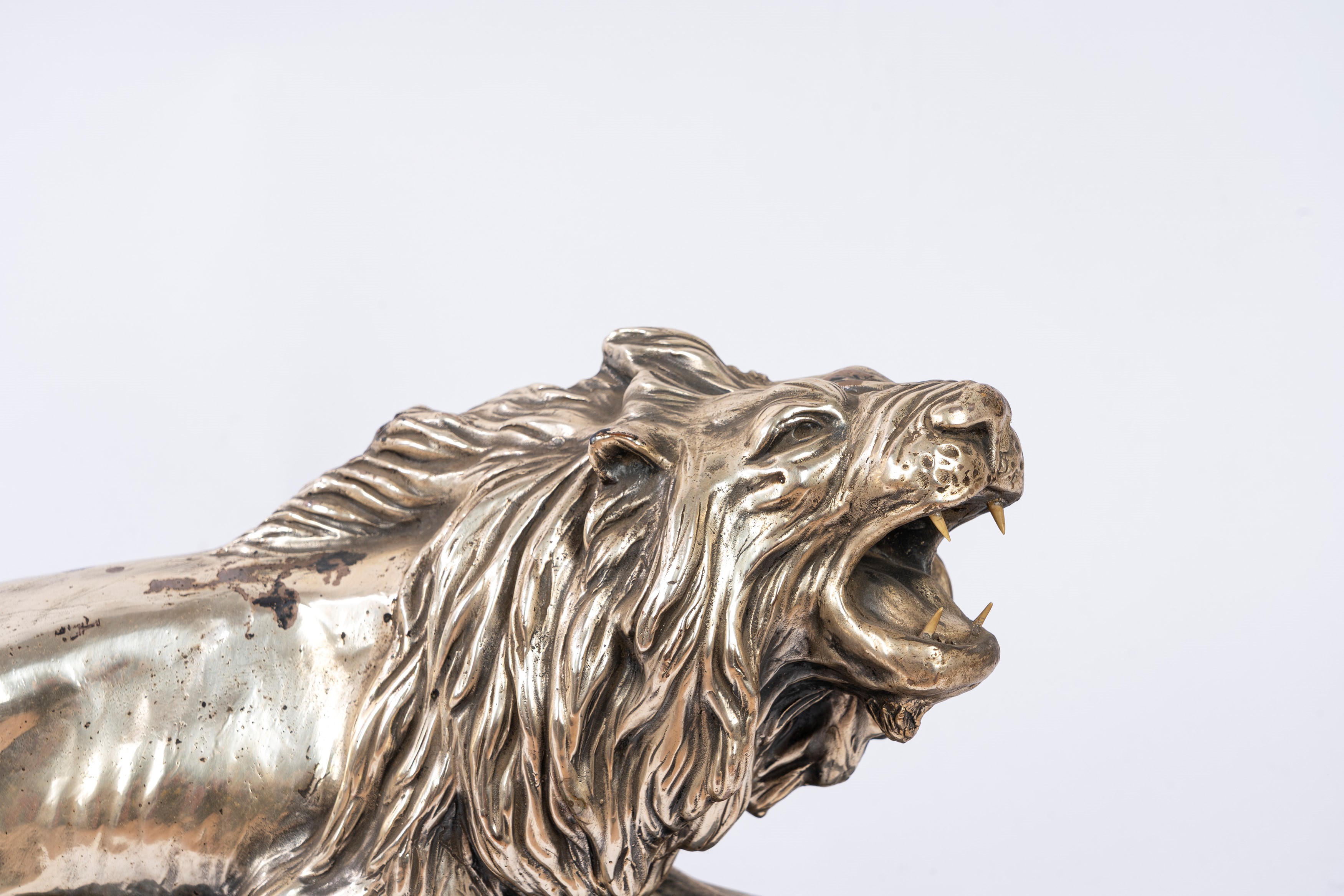 Tornati B., Scultura in terracotta raffigurante leone, con rivestimento in lamina di rame argenta...