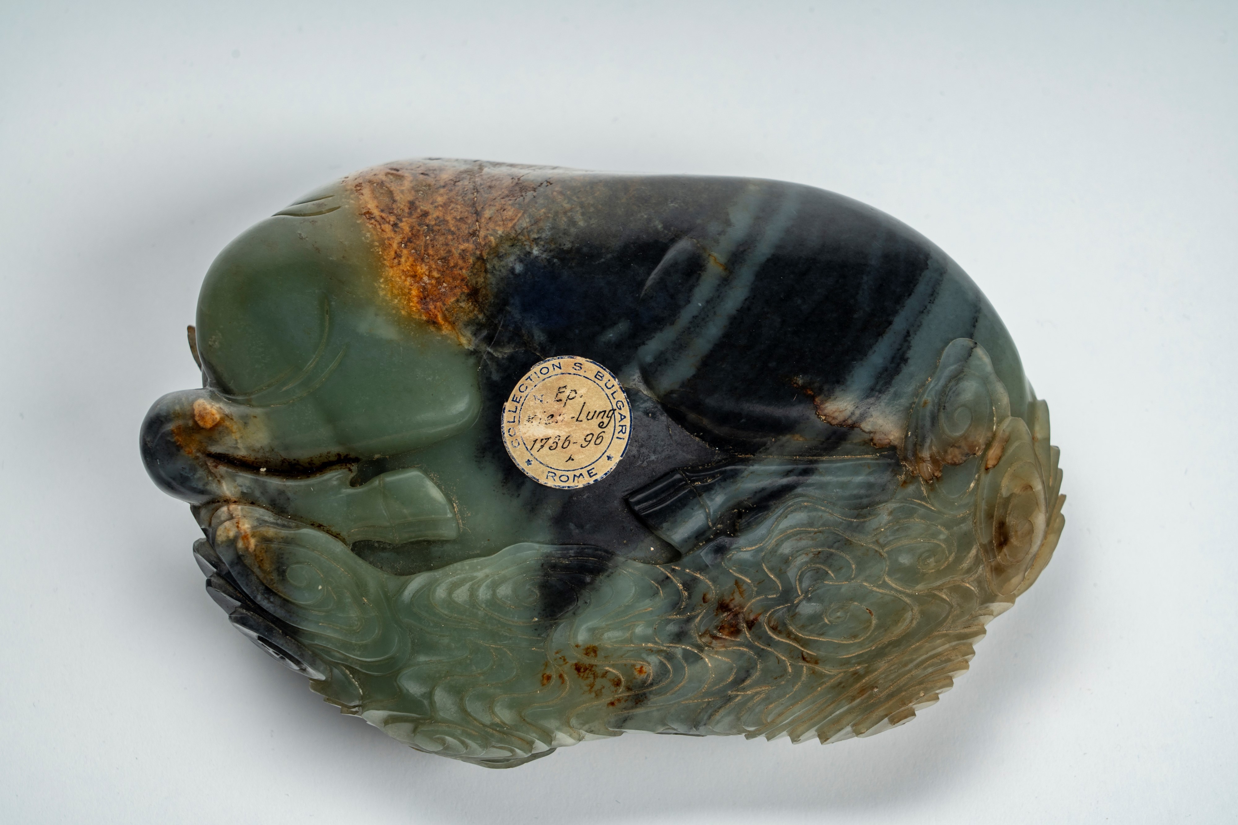 Intaglio in giada marezzata e con russet raffigurante bufalo accovacciato con cane di Fo. Cina, s...