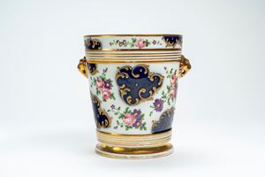 Two-handled porcelain cachepot, decorated with floral bouquets and blue reserves with raised gilt rocaille. Probably France, 19th century